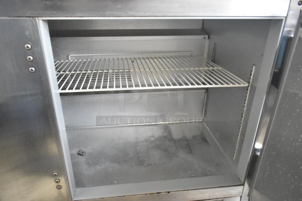 Beverage Air WTR60A stainless steel commercial undercounter cooler, two doors, on casters, interior shelves visible.