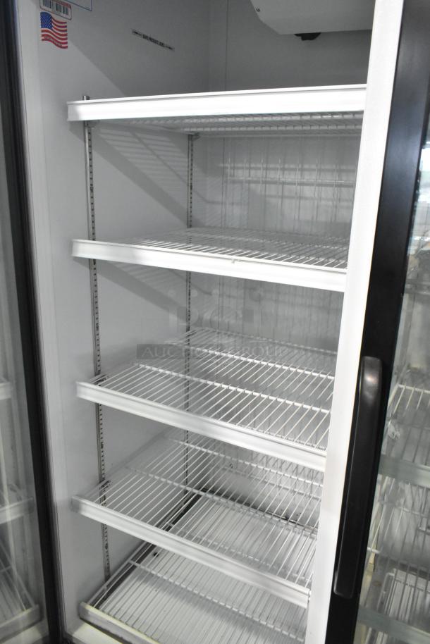 Master-Bilt MBGRP74-HG metal 3-door reach-in cooler with poly coated racks, 115/208-240V, 1 phase, excellent condition.