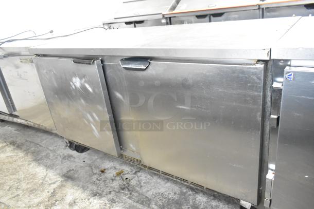 Beverage Air stainless steel 3-door undercounter cooler on commercial casters, 115V, 1 phase, showing signs of wear.