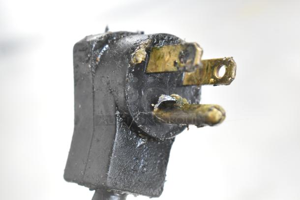 A close-up of a worn plug, associated with the Beverage Air Stainless Steel Commercial 3 Door Undercounter Cooler.