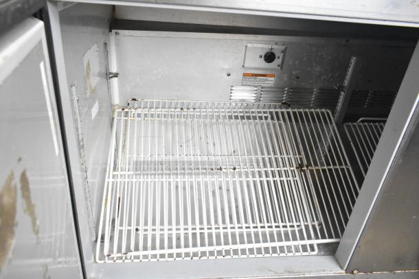 Beverage Air 3-door undercounter cooler in stainless steel, on casters, 115V, 1 Phase, commercial use, interior view.