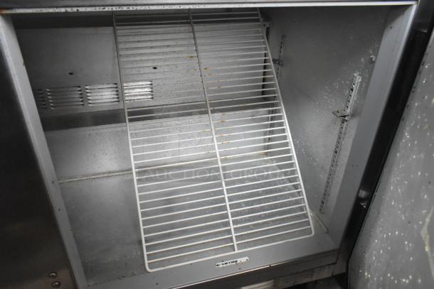 Beverage Air WTR60A stainless steel 3-door undercounter cooler, visible shelving, commercial casters, 115V, used condition.