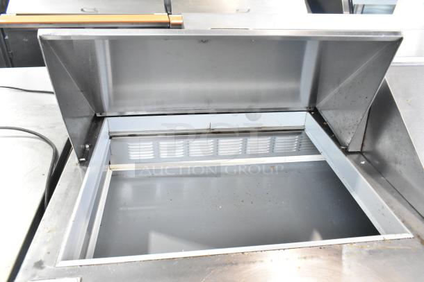 Beverage Air SPE60-24M stainless steel sandwich prep table, open top view, commercial casters, 115V, 1 phase, used condition.