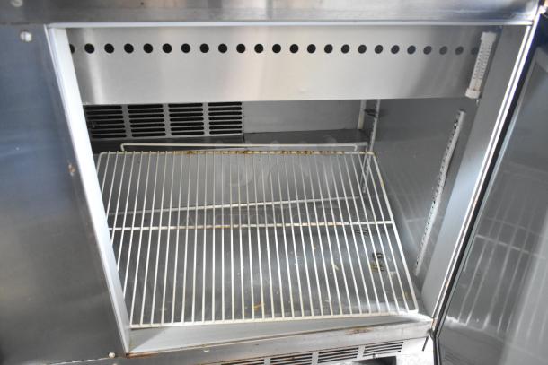 Beverage Air SPE60-24M stainless steel sandwich salad prep table, internal view, commercial casters, 115V, used condition.