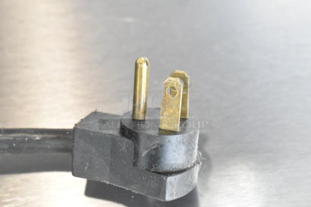 Black power plug for Beverage Air UCR48A undercounter cooler, 115 volts, shown against a metallic background.