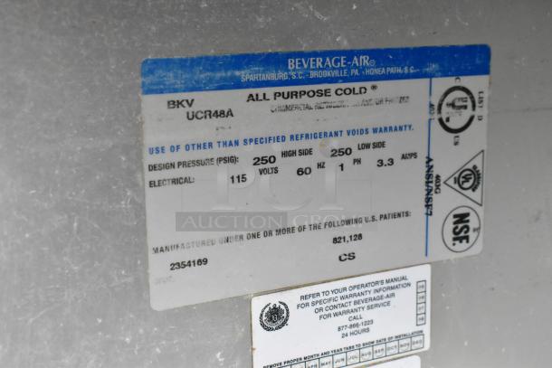 Beverage Air UCR48A stainless steel undercounter cooler, 2 doors, on casters, 115V, 1 phase; label with specs visible.