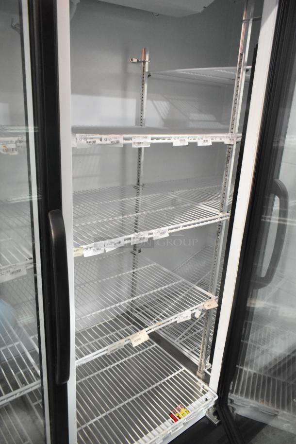Master-Bilt MBGRP74-HG 3-Door Cooler with poly-coated racks. Features metal construction, glass doors, and visible price tags.
