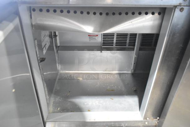 Beverage Air SPE48-18M-HMP stainless steel prep table interior, showing slight signs of use, 115V, commercial casters.