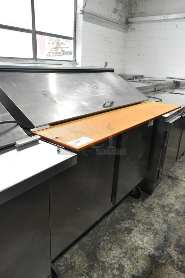 Beverage Air stainless steel sandwich salad prep table with cutting board, commercial casters, 115 volts, 1 phase, used.