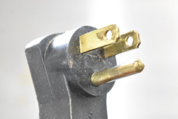 Black and brass electrical plug for Beverage Air commercial prep table, 115 volts, 1 phase, shown in close-up.
