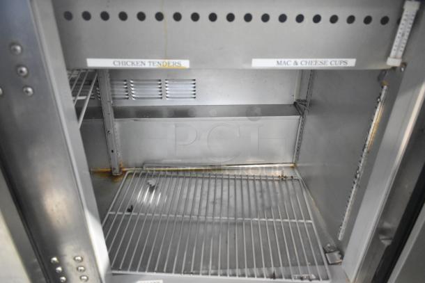 Beverage Air stainless steel prep table interior with shelves, showing labels for "Chicken Tenders" and "Mac & Cheese Cups".