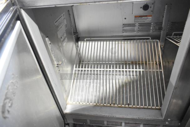 Beverage Air UCR48A stainless steel 2-door undercounter cooler, interior view showing wire shelving, on commercial casters.