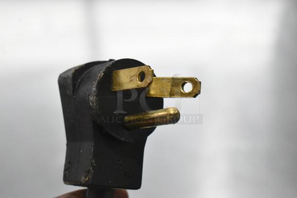 Close-up of electrical plug for Beverage Air UCR48A-23-HMP cooler, showing three prongs with slight wear.