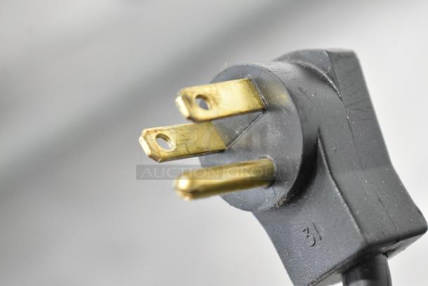 Close-up of a three-prong power plug for the Beverage Air UCR48A commercial cooler, showcasing the gold prongs.