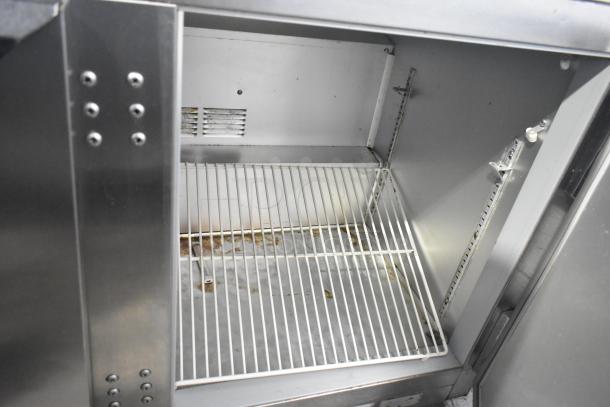 Beverage Air UCR48A stainless steel 2-door undercounter cooler on casters, 115 volts, 1 phase. Interior shelf visible.