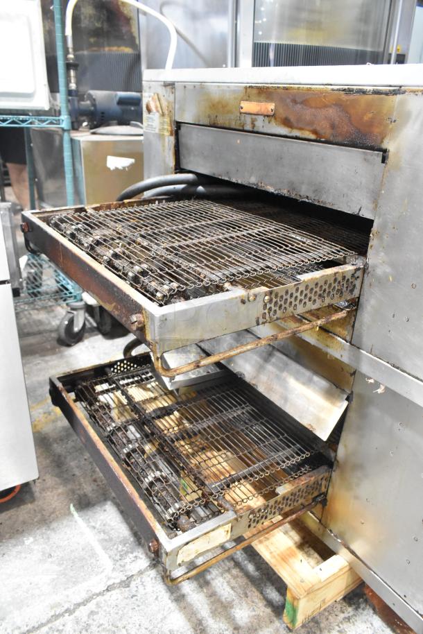 2 Middleby Marshall CTX DZ33I stainless steel pizza ovens, electric, on casters, showing signs of use. Model DZ33I.
