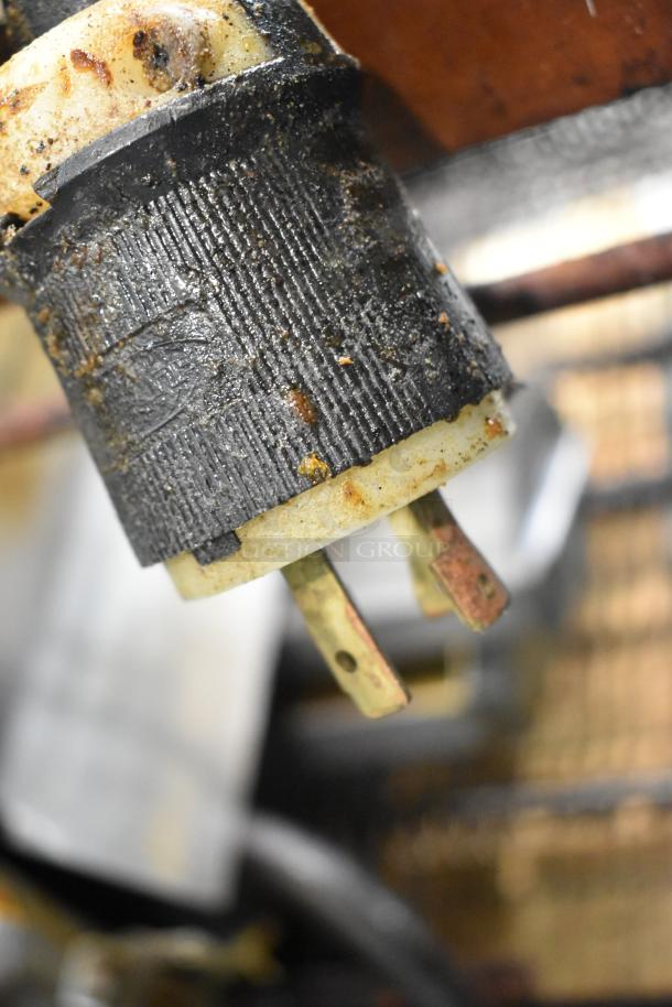 Plug of a Middleby Marshall CTX DZ33I conveyor pizza oven, showing signs of wear and staining, indicative of usage.
