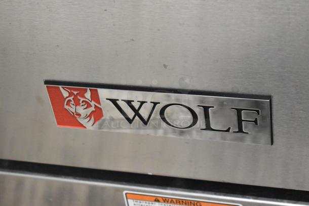 Brand new Wolf C36S-6BP stainless steel 6-burner range with oven. Commercial propane gas, minor scratches.