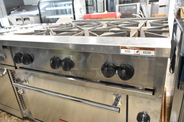 Brand new Wolf C36S-6BP stainless steel 6 burner commercial range with oven, propane, slight scratches, warning label visible.