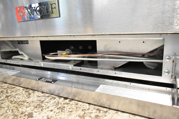 BRAND NEW Wolf C36S-6BP stainless steel 6-burner range, propane gas, commercial oven, with visible scratch and dent.