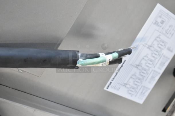 Gray cable on a Wolf C36S-6BP commercial range, showing a circuit diagram in the background.