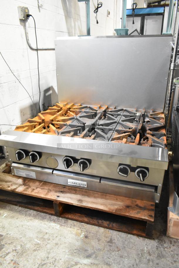 "Garland G36-6T stainless steel 6-burner range, 36'' modular top, natural gas, 198,000 BTU, new scratch and dent condition."