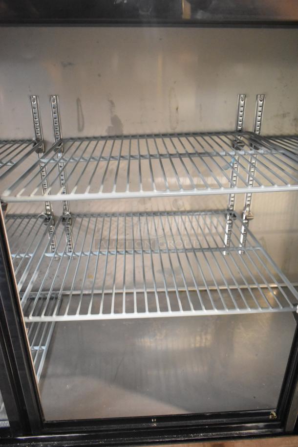 Brand new 2025 Avantco 178UBB72SHC black commercial back bar refrigerator with LED lighting. Sliding glass doors, 73".