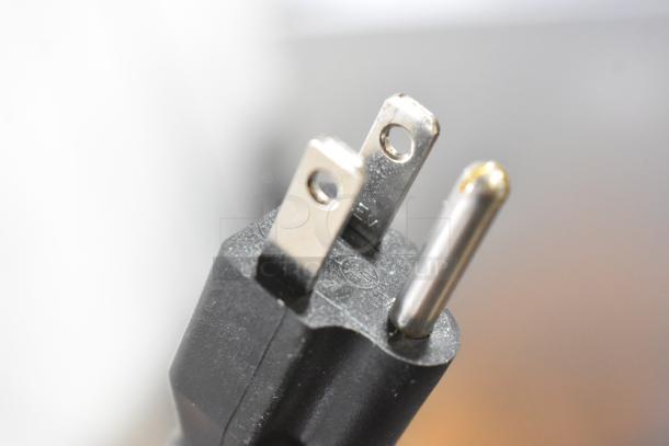 Close-up of a standard three-prong plug for the Avantco 178UBB72SHC refrigerator, showcasing its electrical connection.