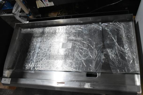 Brand new Cooking Performance Group 48" countertop griddle, stainless steel, natural gas, 120,000 BTU, minor scratches.