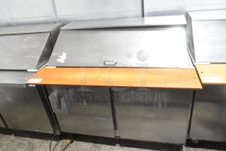 Beverage Air SPE48-18M stainless steel sandwich salad prep table on casters, 115V, 1 phase, commercial use, visible wear.