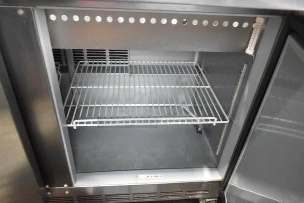 Beverage Air SPE48-18M sandwich salad prep table, stainless steel, commercial casters, empty interior shelves visible.