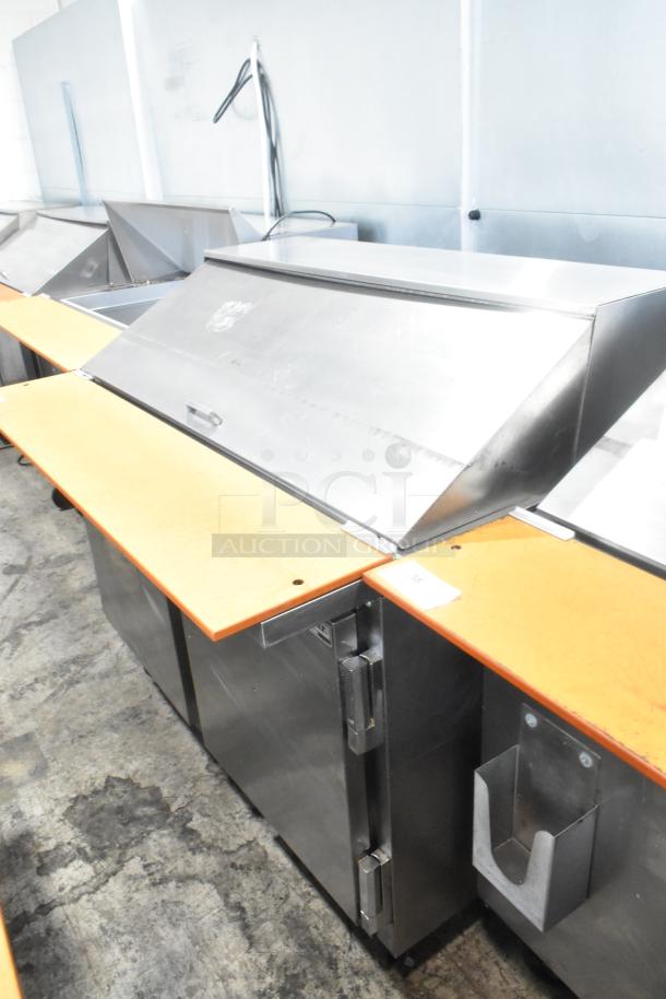 Beverage Air SPE48-18M stainless steel sandwich prep table, commercial casters, 115V, dual compartments, in used condition.