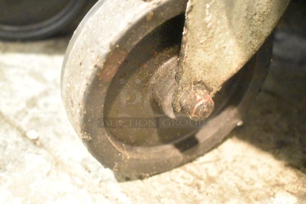 Close-up of a commercial caster wheel from a Beverage Air SPE48-18M-HMP prep table. Slight wear visible on the wheel surface.