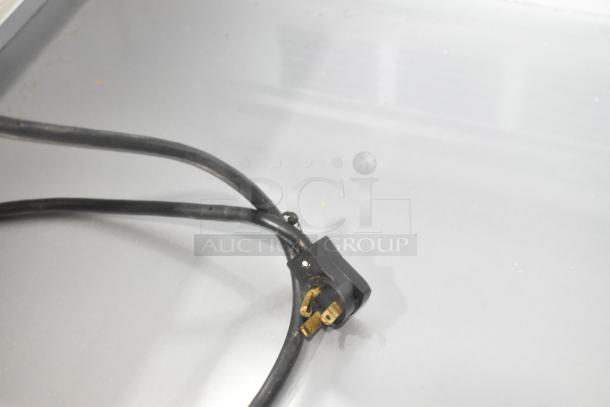 Black power cord and plug for a Beverage Air SPE48-18M-HMP commercial prep table, highlighting the plug's condition.