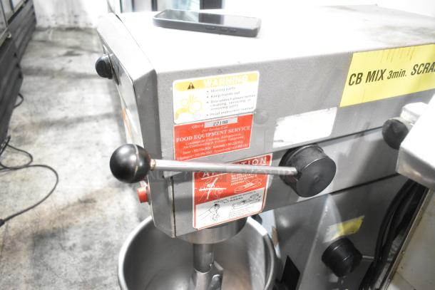 Varimixer W20 commercial 20-quart planetary dough mixer with metal bowl, paddle attachment, warning labels, 115V, 1 phase.