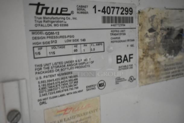 True GDM-12 reach-in cooler label, showing model, voltage 115V, 1 phase, serial number, and energy-saving NSF certification.