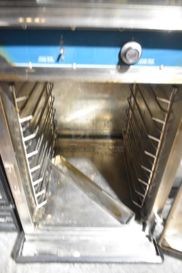 Alto Shaam 1000-TH-I Halo Heat stainless steel commercial oven with racks, on casters. Model on visible blue panel.