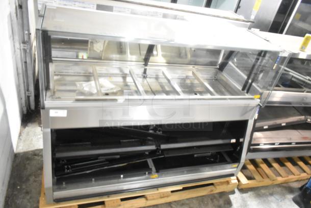 Brand new metal commercial floor-style open grab-and-go merchandiser with visible scratches and dents, on a pallet.