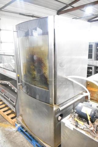 Fri-jado STG7-P stainless steel rotisserie oven. Electric-powered, 208V, 1 phase. Shows signs of use and some wear.