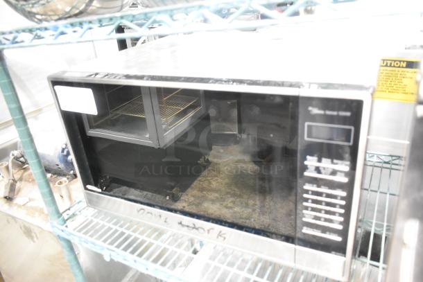 Stainless steel countertop microwave oven, The Genius model, 120V, 1 phase, sleek design, good condition, visible control panel.