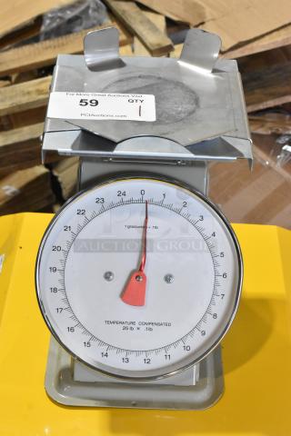 Metal countertop scale with a round dial, red needle, and stainless steel surface. Slight wear visible; marked "Temperature Compensated 25 lb x .1 lb."