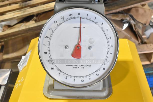 Metal countertop scale with round dial, red pointer, and markings for temperature compensation. Capacity: 25 lb, graduation: 0.1 lb.