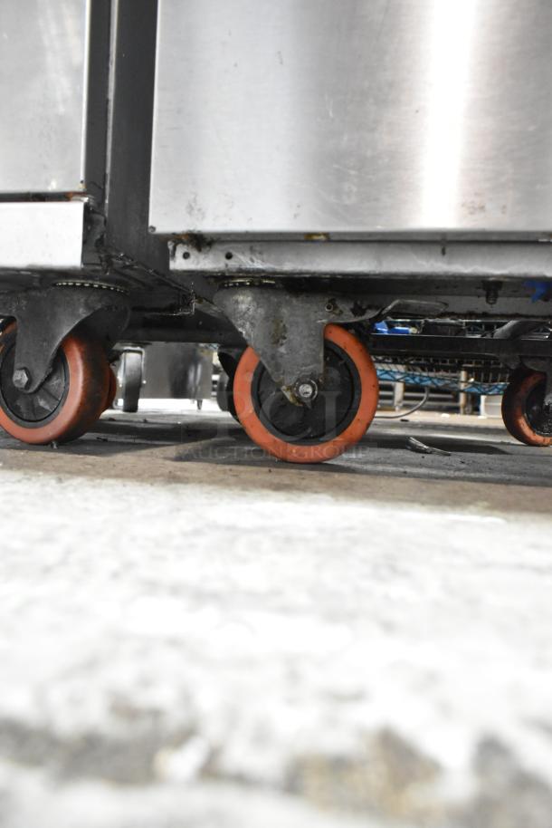 Entree F3-N stainless steel fryer on commercial casters, 90,000 BTU, natural gas, floor style. Visible wear on casters.