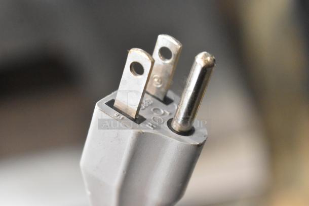 A close-up of a three-prong electrical plug for the 2016 Bizerba GSP HD metal meat slicer, 120 volts, 1 phase.