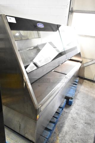 Metal commercial floor-style merchandiser with glass display, built-in lighting, and stainless steel construction; moderate wear.
