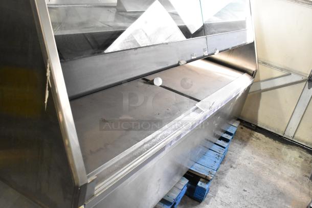 Metal commercial floor style merchandiser in used condition, features a robust metal frame and ample display space.