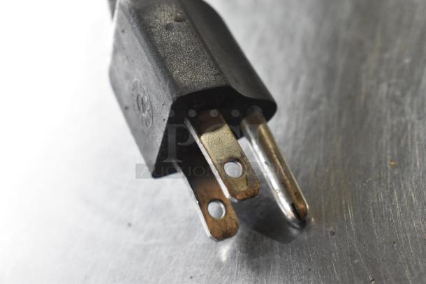 Black power plug for Leader Stainless Steel Commercial Undercounter Cooler, 115 volts, 1 phase, showing prongs and casing detail.