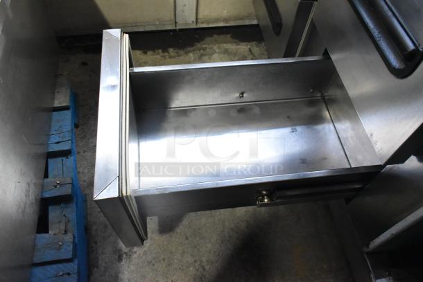 Leader stainless steel 4-drawer undercounter cooler with commercial casters, 115 volts, 1 phase, open drawer view.