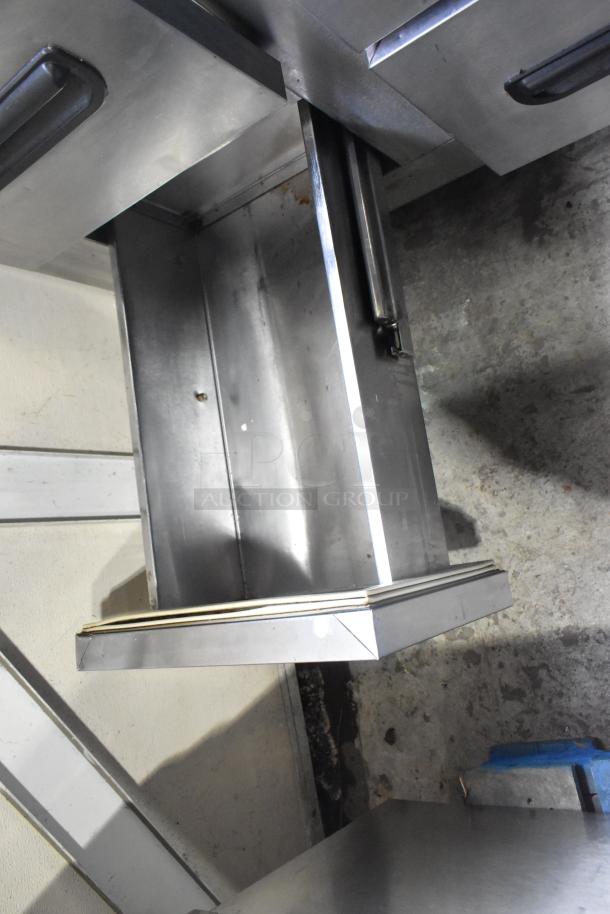 Leader stainless steel 4-drawer undercounter cooler, commercial casters, 115V, 1 phase. Open drawer view. Good condition.