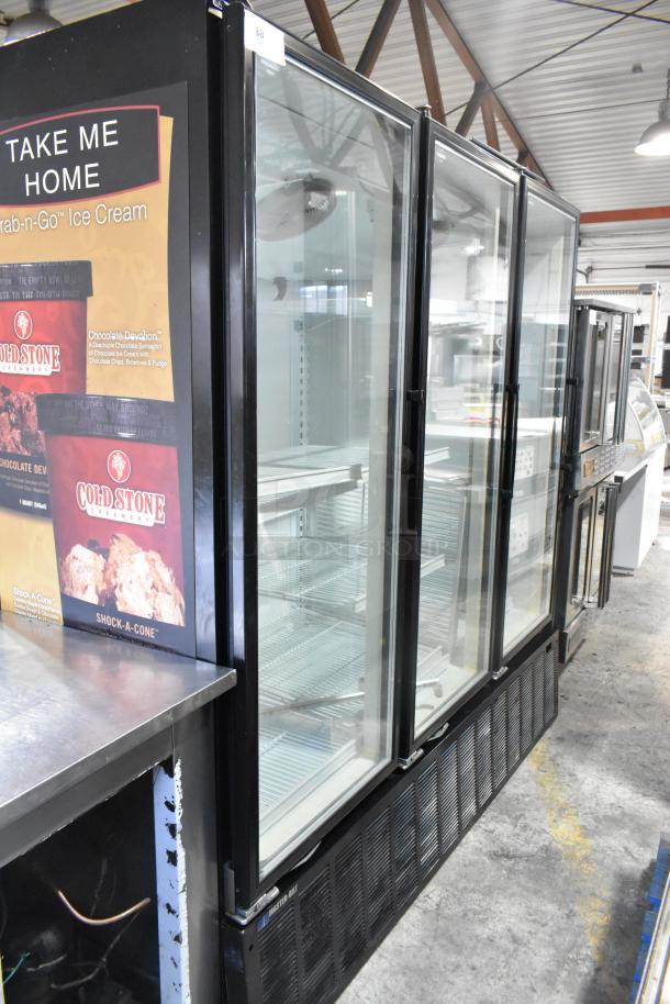 Master-Bilt BLG-74HD 3-door reach-in freezer merchandiser with poly-coated racks, glass doors, and metal frame in good condition.